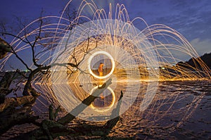 Firework and fire swing on dead tree fourground