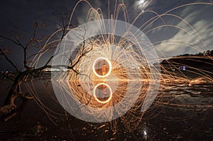 Firework and fire swing on dead tree fourground