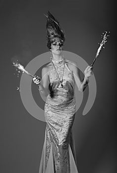 Firework holding woman in eveningdress with upright hair