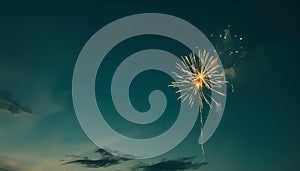 Firework over the blue sky at night, white, and green