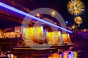 Firework over bridge night city reflected in water Uzhorod