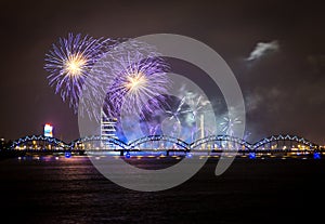 Firework in Riga over the river with bridge