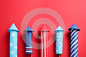 Firework rockets on red background, space for text