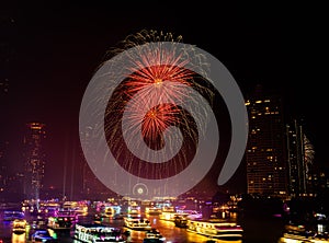 Firework show along Chao Praya River on the side of the Asiatique landmark plaza in Bangkok