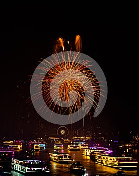 Firework show along Chao Praya River on the side of the Asiatique landmark plaza in Bangkok