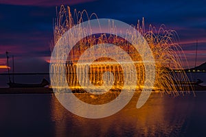 Firework showers of hot glowing sparks from spinning steel wool