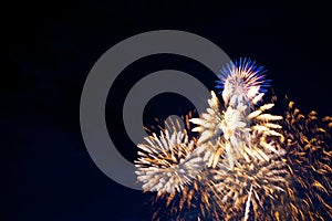 Fireworks on the background of the cloudy night sky. 4th of July - American Independence Day USA