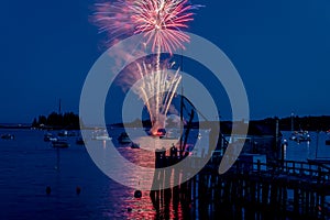 Fireworks on Boothbay Harbor, Maine, reflect off the water on July 4th