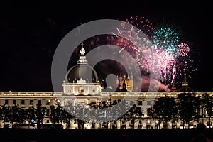 Fireworks bursting over Hotel Dieu in Lyon for French National Holiday, Bastille day, while Basilique de Fourviere Basilica church