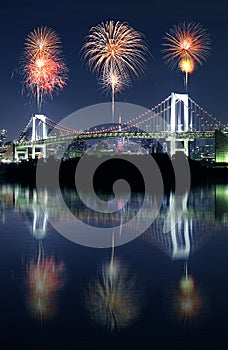 Fireworks celebrating with mirror reflection over Tokyo Rainbow