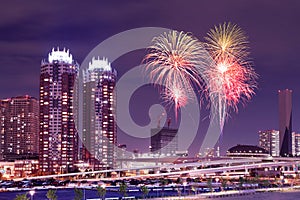 Fireworks celebrating over Tokyo cityscape at nigh