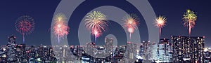 Fireworks celebrating over Tokyo cityscape at night, Japan