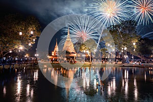 Fireworks celebration of Loy Krathong at Sukhothai Historical Park festival, buddha pagoda stupa in a temple, Sukhothai, Thailand