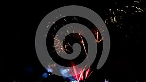 Fireworks float in the pitch black sky photo