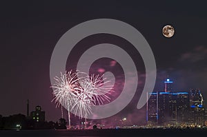 Fireworks with full moon over detroit river