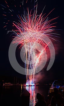 Red fireworks explode over the Tchefuncte River in Madisonville, Louisiana photo