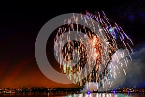 Fireworks lights over the ocean in a big city