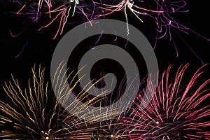 Fireworks at night pyrotechnics sky explosions celebration bright glowing light background