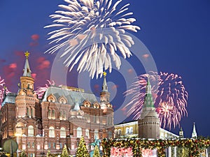 Fireworks over the Christmas New Year holidays illumination and State Historical Museum inscription in Russian,Moscow, Russia