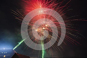 Fireworks over the snowy roofs on New Year`s Eve