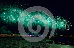 Fireworks over the water Holiday light. Night cityscape scene. Neva river, Saint-Petersburg, Russia. Holiday Scarlet Sails