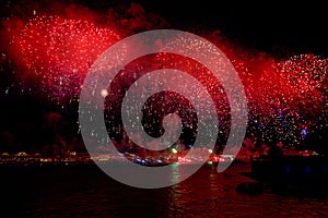 Fireworks over the water Holiday light. Night cityscape scene. Neva river, Saint-Petersburg, Russia. Holiday Scarlet Sails