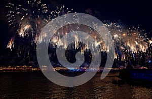 Fireworks over the water Holiday light. Night cityscape scene. Neva river, Saint-Petersburg, Russia. Holiday Scarlet Sails