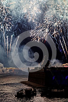 Fireworks over the water Holiday light. Night cityscape scene. Neva river, Saint-Petersburg, Russia. Holiday Scarlet Sails