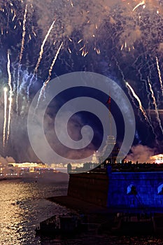 Fireworks over the water Holiday light. Night cityscape scene. Neva river, Saint-Petersburg, Russia. Holiday Scarlet Sails