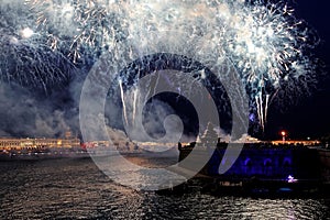 Fireworks over the water Holiday light. Night cityscape scene. Neva river, Saint-Petersburg, Russia. Holiday Scarlet Sails