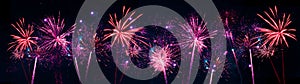 Fireworks pyrotechnics celebration party event festival holiday or New Year background panorama - Pink red firework on dark night