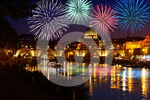 Fireworks on St peter Cathedral skyline in Rome view from Umberto I bridge on Tiber river