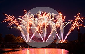 fireworks on stoned bridge on the Orb River with reflection in Beziers in France