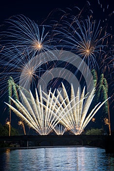 fireworks on stoned bridge on the Orb River with reflection in Beziers in France