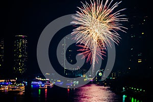 Fireworks to celebrate the festival of New Year at Bangkok Thailand. The light reflected the Chao Phraya River