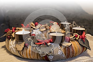 First Advent. Beautiful closeup of Advent wreath made from natural materials and ceramic decors