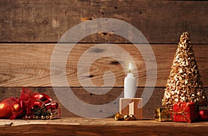 First Advent candle burning on a rustic wooden table