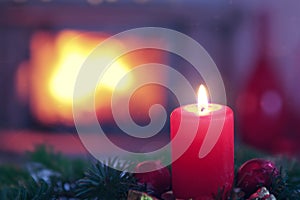 First Advent candles on blurred fireplace background
