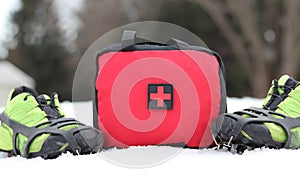 First Aid Bag Standing In The Snow With Shoes With Spikes