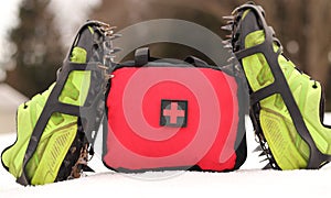 First Aid Bag Standing In The Snow With Shoes And Spikes Standing Up