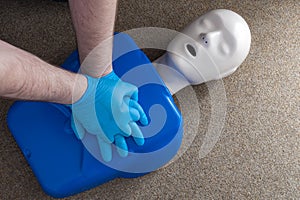 First aid and cardiopulmonary resuscitation training on a CPR dummy, a human shaped doll used to improve the skills and technique