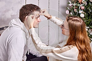 First aid for domestic trauma, woman uses an adhesive bandage to seal her boyfriend wound.