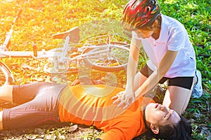 First Aid Emergency is CPR.The man who face heart attack and shock was helped by his friend after the bicycle race.