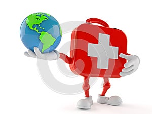 First aid kit character holding world globe