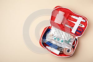 First aid kit on color background, top view