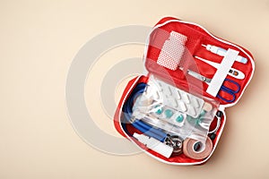 First aid kit on color background, top view photo