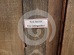 First aid kit fire extinguisher sign on wood door