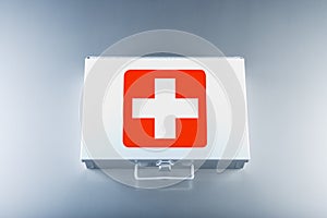 First aid kit on grey background photo