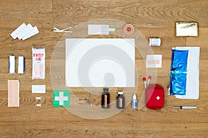 First Aid kit items aligned on wooden surface with copy space ar