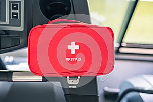 First aid kit red box in the fitness gym opposite the sport equipment and  jogging simulators. Healthy lifestyle, safety and help